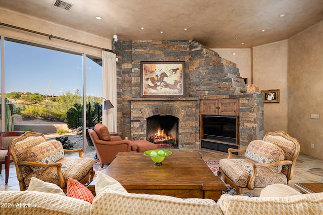 living room featuring a stone fireplace