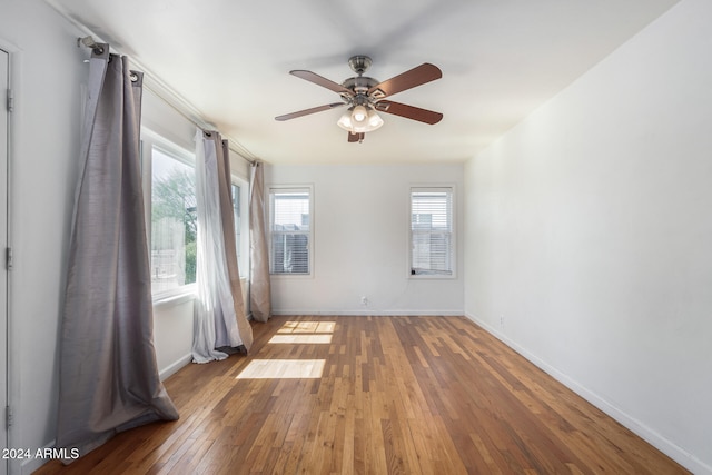 empty room featuring ceiling fan and hardwood / wood-style floors