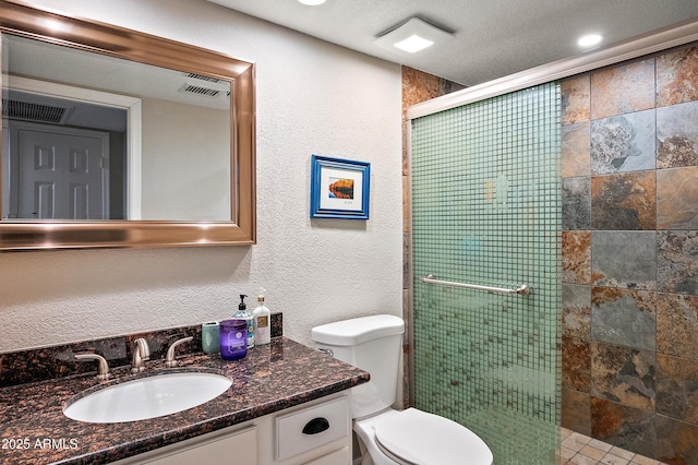 bathroom with vanity, toilet, and walk in shower