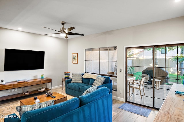 living room featuring hardwood / wood-style flooring and ceiling fan