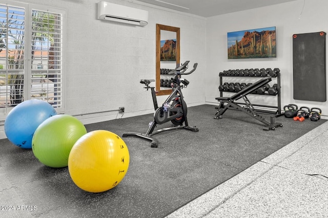 workout area featuring a wall mounted air conditioner