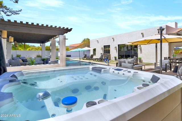 view of swimming pool with an outdoor living space and a hot tub