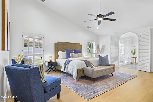 bedroom with hardwood / wood-style flooring, ceiling fan, high vaulted ceiling, and multiple windows