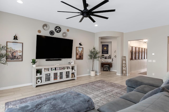 living room featuring hardwood / wood-style flooring and ceiling fan