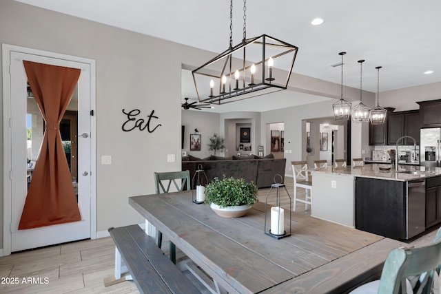 dining room featuring ceiling fan and sink