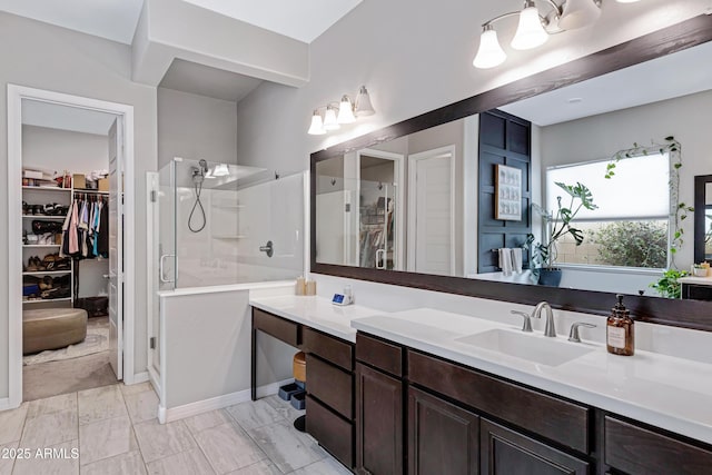 bathroom with a shower with door and vanity