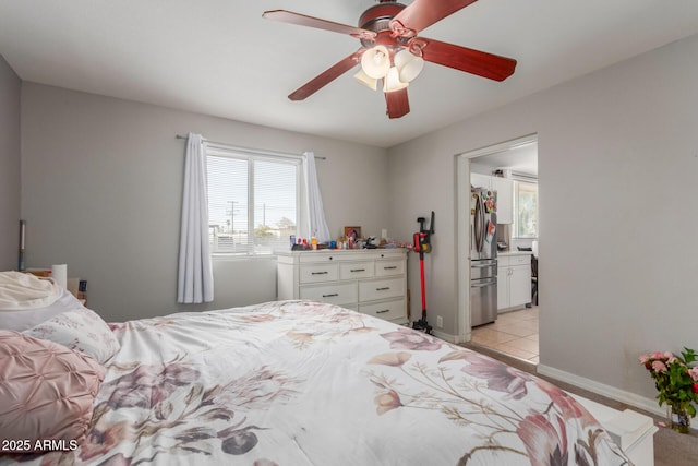 tiled bedroom featuring ceiling fan and stainless steel refrigerator