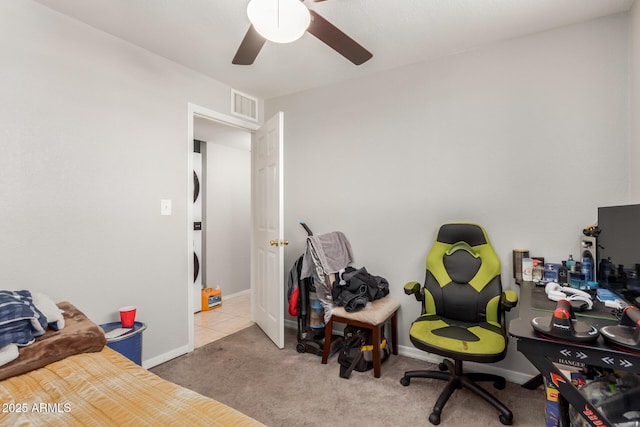 carpeted office space featuring ceiling fan