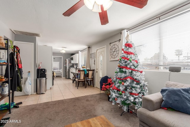 tiled living room with ceiling fan