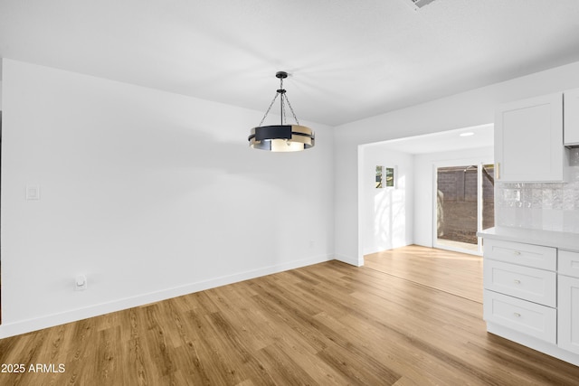 unfurnished dining area with light hardwood / wood-style floors