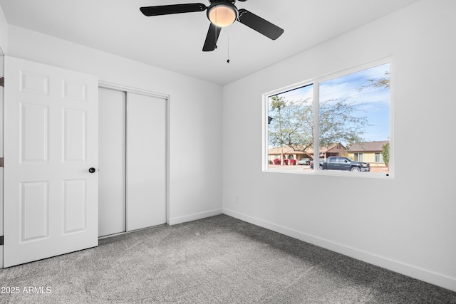 unfurnished bedroom with ceiling fan, light colored carpet, and a closet