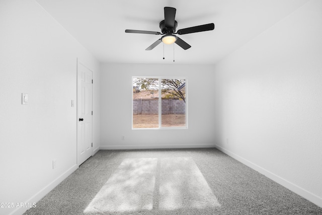 unfurnished room with ceiling fan and light carpet