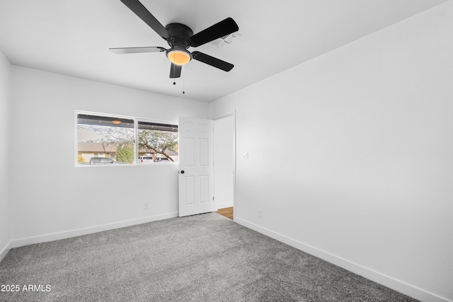 unfurnished room featuring ceiling fan and carpet floors