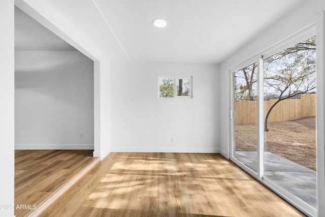 unfurnished room with hardwood / wood-style floors