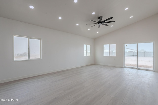 unfurnished room with ceiling fan, vaulted ceiling, and light hardwood / wood-style flooring