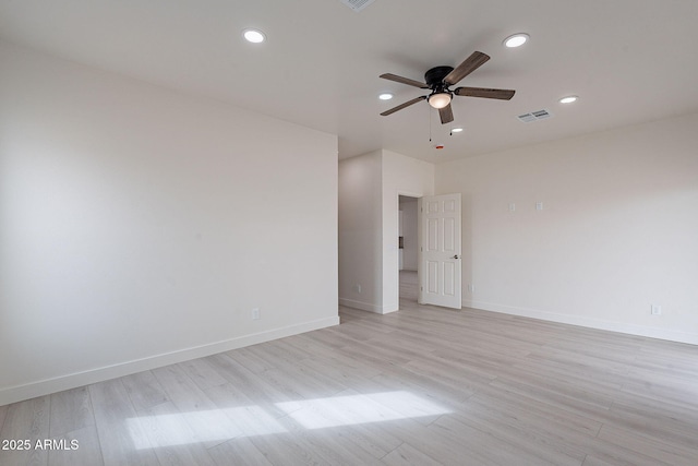 spare room featuring light hardwood / wood-style flooring and ceiling fan