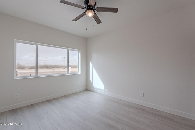 empty room featuring ceiling fan and light hardwood / wood-style flooring