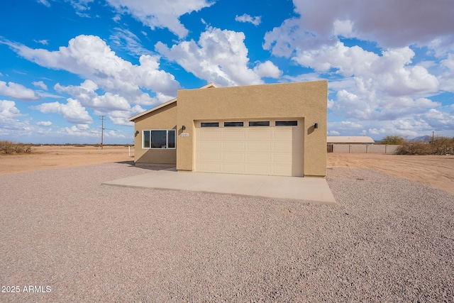 pueblo-style home with a garage