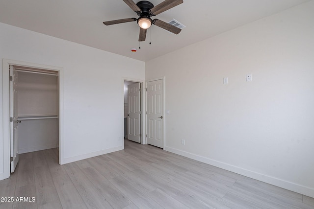 unfurnished bedroom with ceiling fan and light hardwood / wood-style flooring