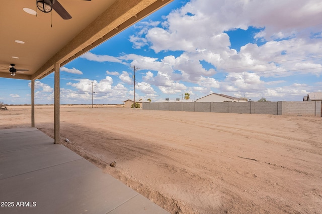 view of yard with a patio area and ceiling fan