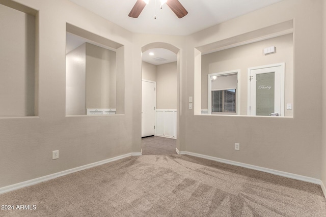 spare room with light carpet and ceiling fan