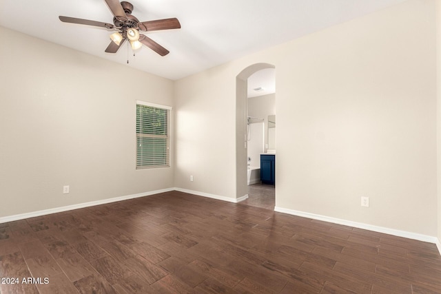 empty room featuring ceiling fan and dark wood-type flooring