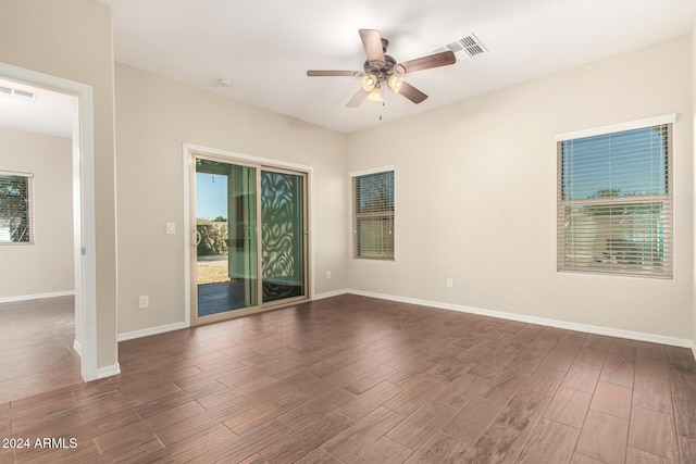 unfurnished room featuring ceiling fan and dark hardwood / wood-style flooring