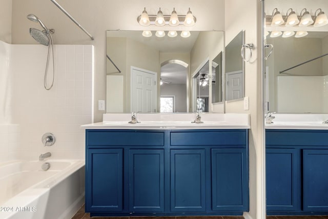 bathroom featuring shower / bathing tub combination, vanity, and ceiling fan