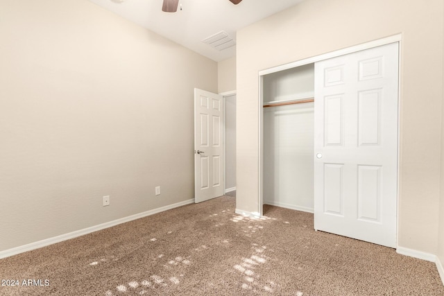 unfurnished bedroom with ceiling fan, carpet floors, and a closet