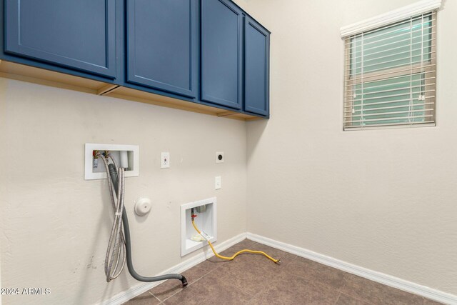 washroom with cabinets, hookup for a washing machine, hookup for an electric dryer, tile patterned floors, and gas dryer hookup