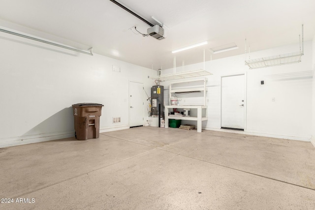 garage with a garage door opener and water heater