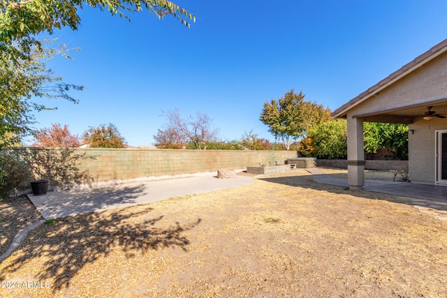 view of yard featuring a patio and ceiling fan