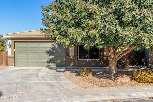 obstructed view of property with a garage