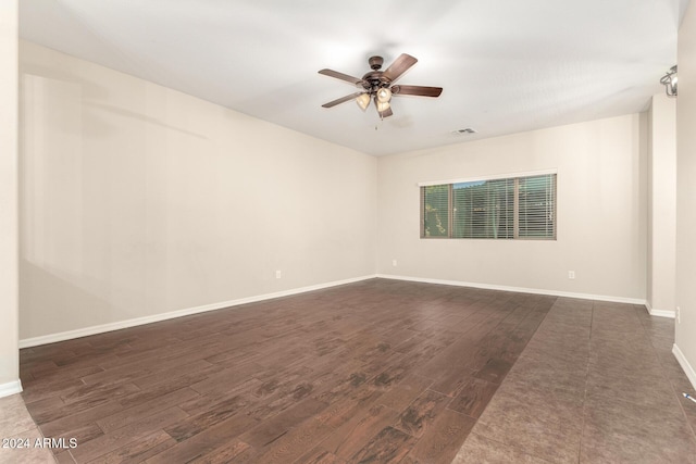 empty room with ceiling fan and dark wood-type flooring