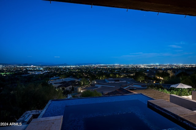 view of pool at dusk