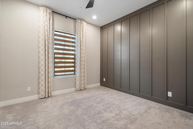 empty room with recessed lighting, light colored carpet, plenty of natural light, and baseboards