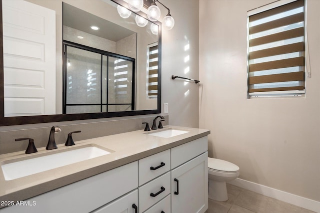 full bathroom with double vanity, a stall shower, a sink, and tile patterned floors