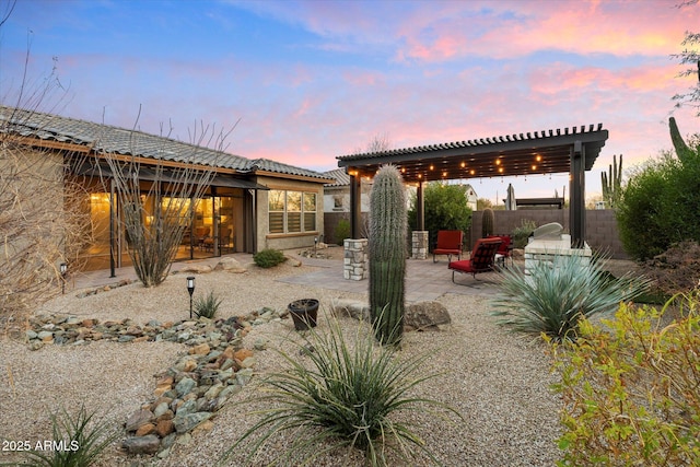 back of property featuring a tile roof, fence, a patio area, a pergola, and stucco siding