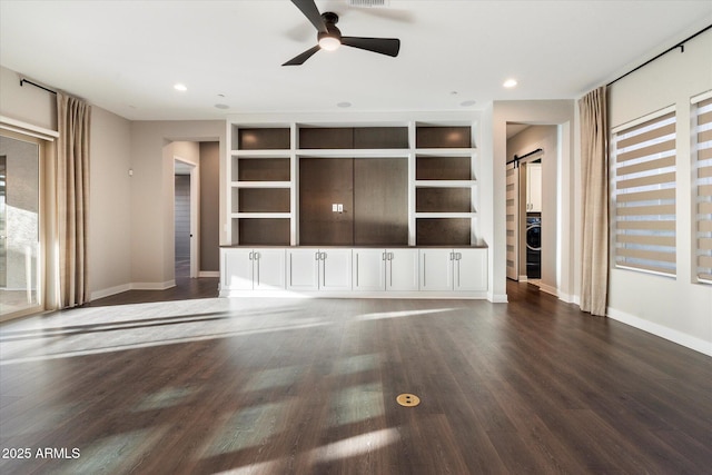 unfurnished living room featuring recessed lighting, washer / clothes dryer, a barn door, ceiling fan, and wood finished floors