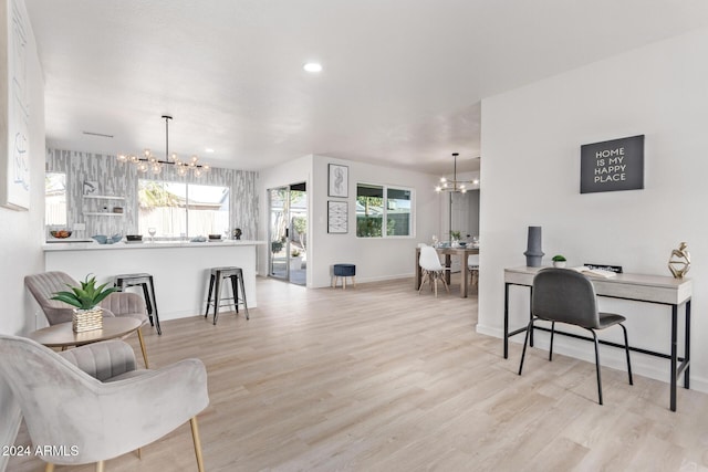 living room featuring an inviting chandelier and light hardwood / wood-style flooring