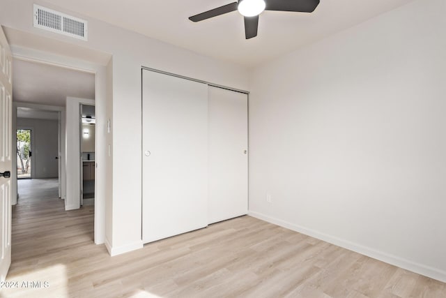 unfurnished bedroom with a closet, ceiling fan, and light wood-type flooring