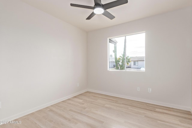 spare room with ceiling fan and light wood-type flooring