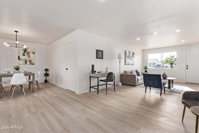 interior space featuring an inviting chandelier and light hardwood / wood-style floors