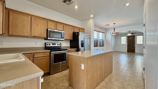 22507 N 31st Ave # 11, Phoenix, AZ 85027 - kitchen featuring appliances with stainless steel finishes, a chandelier, light tile patterned flooring, a kitchen island, and light countertops