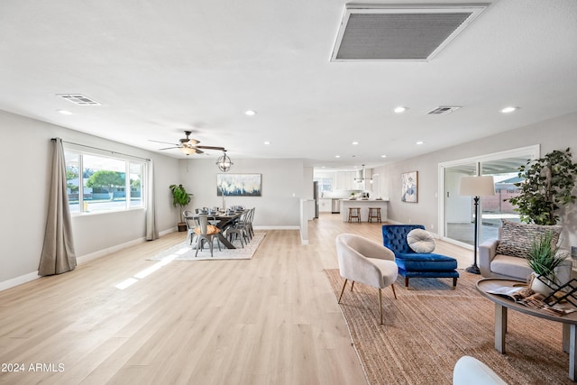 living room with ceiling fan and light wood-type flooring