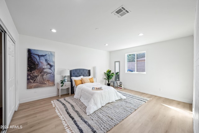 bedroom featuring light hardwood / wood-style floors and a closet