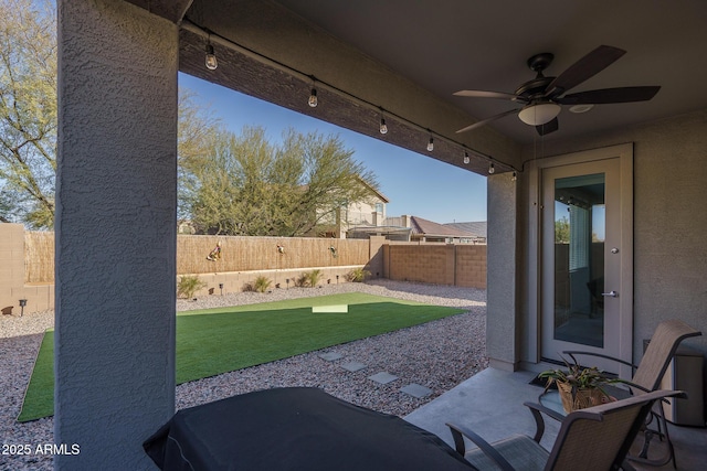 view of patio featuring ceiling fan