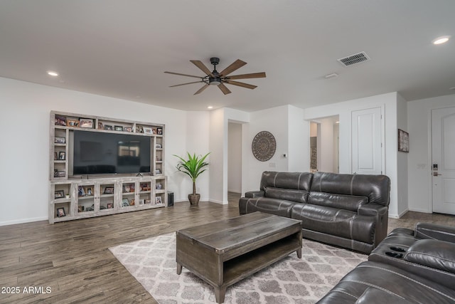 living room featuring hardwood / wood-style flooring and ceiling fan