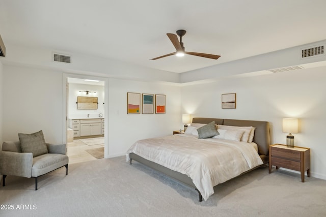 carpeted bedroom featuring ceiling fan and ensuite bathroom