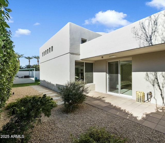 rear view of property featuring a patio